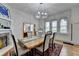 Bright dining room with hardwood floors, a rustic wooden table, and a view into other rooms at 799 Monroe Ne Dr, Atlanta, GA 30308