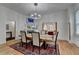 Open dining room with hardwood floors, a rustic wooden table, and a fireplace at 799 Monroe Ne Dr, Atlanta, GA 30308
