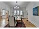 Dining room features a modern chandelier, hardwood floors, and a rustic wooden table at 799 Monroe Ne Dr, Atlanta, GA 30308