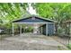 Exterior view of the home featuring a spacious carport and secure gate to the private backyard at 799 Monroe Ne Dr, Atlanta, GA 30308
