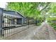Exterior view of the home featuring the carport, backyard gate, and driveway at 799 Monroe Ne Dr, Atlanta, GA 30308