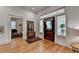 Inviting foyer with hardwood floors, a decorative mirror, and a glimpse into the living room at 799 Monroe Ne Dr, Atlanta, GA 30308