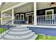 Inviting front porch with decorative columns, a hanging lantern, and a detailed front door at 799 Monroe Ne Dr, Atlanta, GA 30308