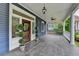 Spacious tiled front porch with ceiling fan and stained glass wood door for a vintage touch at 799 Monroe Ne Dr, Atlanta, GA 30308