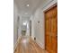 Hallway with hardwood floors, white walls, and multiple doors leading to other rooms at 799 Monroe Ne Dr, Atlanta, GA 30308