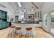 Bright kitchen featuring an island with seating, stainless steel appliances, and custom cabinetry at 799 Monroe Ne Dr, Atlanta, GA 30308