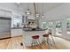 Bright kitchen features an island with bar seating, stainless steel appliances, and hardwood floors at 799 Monroe Ne Dr, Atlanta, GA 30308