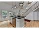 Bright kitchen features an island with bar seating, stainless steel appliances, and hardwood floors at 799 Monroe Ne Dr, Atlanta, GA 30308