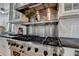 Close up of a stainless steel stove with six burners and a stainless steel range hood at 799 Monroe Ne Dr, Atlanta, GA 30308
