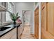 Bright kitchen featuring black countertops, stainless steel appliances, and gleaming hardwood floors with a view to the backyard at 799 Monroe Ne Dr, Atlanta, GA 30308