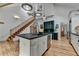 Modern kitchen with pendant lighting, island with sink, stainless steel appliances, and hardwood floors at 799 Monroe Ne Dr, Atlanta, GA 30308