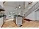 Spacious kitchen with high ceilings, a central island, modern appliances and stair access at 799 Monroe Ne Dr, Atlanta, GA 30308