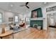 Bright and open living room with hardwood floors, a green fireplace, and neutral-toned furniture at 799 Monroe Ne Dr, Atlanta, GA 30308