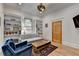 Bright living room featuring built-in bookshelves, a comfortable gray couch, and hardwood floors at 799 Monroe Ne Dr, Atlanta, GA 30308