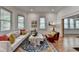 Bright living room with large windows and a stylish rug on hardwood floors at 799 Monroe Ne Dr, Atlanta, GA 30308