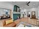 Open-concept living room with a decorative fireplace and hardwood floors at 799 Monroe Ne Dr, Atlanta, GA 30308