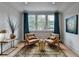 Sitting area featuring two chairs, a window with curtains, and a rug at 799 Monroe Ne Dr, Atlanta, GA 30308