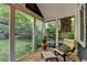 Relaxing sunroom featuring terra cotta tile and a view of the landscaped backyard at 799 Monroe Ne Dr, Atlanta, GA 30308
