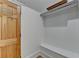 Walk-in closet featuring a wood door, ample shelving, and storage space at 799 Monroe Ne Dr, Atlanta, GA 30308