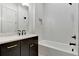 Bathroom featuring a bathtub/shower combination with white tile and a black vanity with white countertops at 150 Rolison Way, Fayetteville, GA 30214