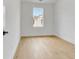 Bright, simple bedroom with white walls, wood floor, white trim, and a window providing natural light at 150 Rolison Way, Fayetteville, GA 30214