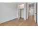 Bedroom featuring light wood flooring, a closet, and white trim leading to a hallway with bright lighting at 150 Rolison Way, Fayetteville, GA 30214
