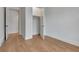 Bedroom featuring light wood flooring, a closet, and white trim leading to a hallway with bright lighting at 150 Rolison Way, Fayetteville, GA 30214