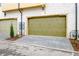 View of the exterior of the garages; doors are wood and a light olive color at 150 Rolison Way, Fayetteville, GA 30214