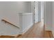 Upstairs hallway with wood floors and stairway with wood trim at 150 Rolison Way, Fayetteville, GA 30214
