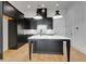 Modern kitchen with dark cabinetry, a white countertop island, and stainless steel appliances at 150 Rolison Way, Fayetteville, GA 30214