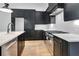 Modern kitchen features stainless steel appliances, white countertops, and sleek, dark cabinetry at 150 Rolison Way, Fayetteville, GA 30214