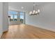 Bright living room with hardwood floors and a modern chandelier fixture at 150 Rolison Way, Fayetteville, GA 30214
