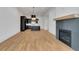 Living room showcasing a fireplace with tile surround, and an open concept view to the kitchen at 150 Rolison Way, Fayetteville, GA 30214