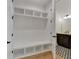 Mudroom with built-in storage leading to a powder room with stylish patterned floors at 150 Rolison Way, Fayetteville, GA 30214