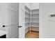 Walk-in pantry offers ample storage space with multiple shelves for organized kitchen essentials at 150 Rolison Way, Fayetteville, GA 30214