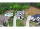 Aerial view of a two-story home with a swimming pool, landscaped yard, and long driveway at 1525 Tapestry Rdg, Lawrenceville, GA 30045