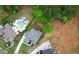 An overhead shot of a luxury residence with a swimming pool, long driveway, and mature tree coverage at 1525 Tapestry Rdg, Lawrenceville, GA 30045