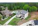 Aerial view of a two-story home with a swimming pool, landscaped yard, and long driveway at 1525 Tapestry Rdg, Lawrenceville, GA 30045