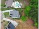 Aerial view of a two-story home with a swimming pool, landscaped yard, and long driveway at 1525 Tapestry Rdg, Lawrenceville, GA 30045