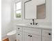Modern bathroom with a stylish vanity, black hardware, and wood floors at 1525 Tapestry Rdg, Lawrenceville, GA 30045