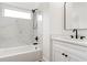 Modern bathroom showcasing stylish black fixtures, marble-style tile, a soaking tub and glass enclosed shower at 1525 Tapestry Rdg, Lawrenceville, GA 30045