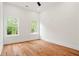 An airy, light-filled bedroom featuring beautiful hardwood floors, crisp white walls, and well-trimmed windows at 1525 Tapestry Rdg, Lawrenceville, GA 30045