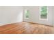 Bright bedroom offering hardwood floors and a view of nature outside at 1525 Tapestry Rdg, Lawrenceville, GA 30045
