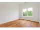 A bright bedroom featuring hardwood floors, crisp white walls, base trim and a picture window at 1525 Tapestry Rdg, Lawrenceville, GA 30045