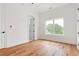 A bright, spacious bedroom featuring hardwood floors, crisp white walls, a window, and a closet at 1525 Tapestry Rdg, Lawrenceville, GA 30045
