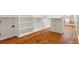Spacious closet features custom built-in shelving, drawers, a center island, and beautiful hardwood floors at 1525 Tapestry Rdg, Lawrenceville, GA 30045