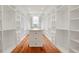 Spacious closet features custom built-in shelving, drawers, a center island, and beautiful hardwood floors at 1525 Tapestry Rdg, Lawrenceville, GA 30045