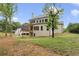 Exterior of a large, two-story home with a brick facade, covered porch, and a spacious backyard at 1525 Tapestry Rdg, Lawrenceville, GA 30045