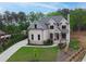 Charming two-story brick home featuring a landscaped yard and a spacious driveway at 1525 Tapestry Rdg, Lawrenceville, GA 30045