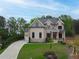 Charming two-story brick home featuring a landscaped yard and a spacious driveway at 1525 Tapestry Rdg, Lawrenceville, GA 30045